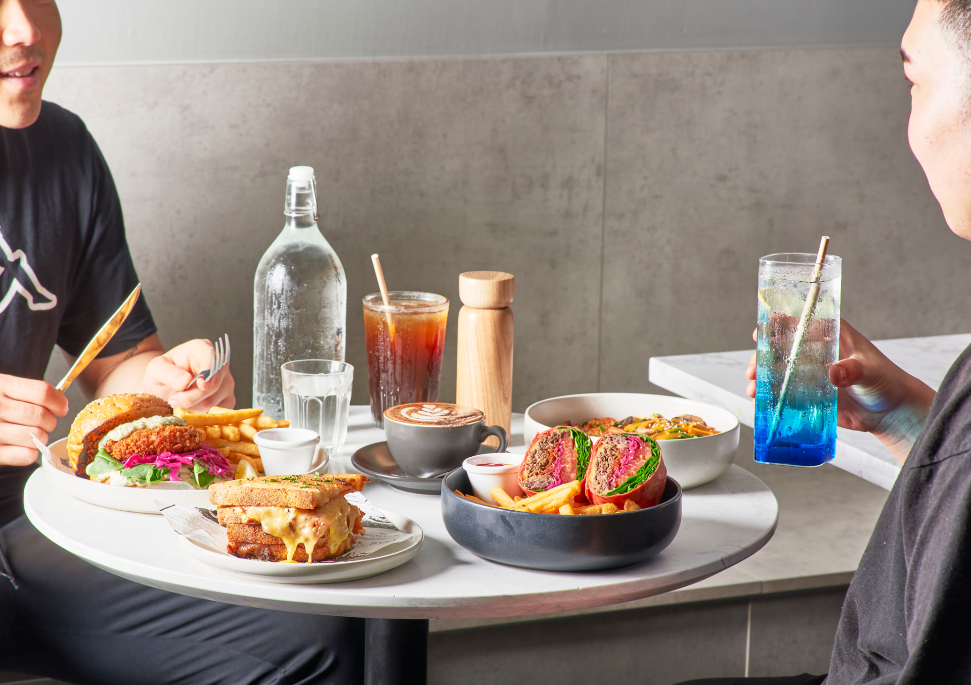 Friends sharing plates at Boom Cafe & Dining